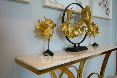Elegant interior decor with gold fish sculptures on a marble console table.