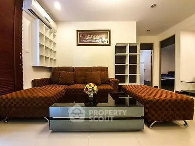 Spacious living room with modern furniture and elegant decor, perfect for relaxation and entertainment.
