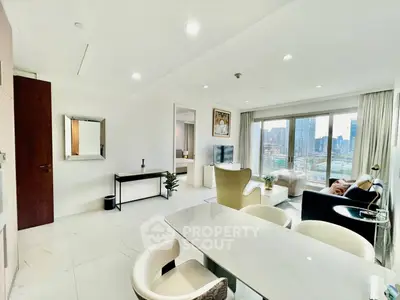 Spacious modern living room with city view, elegant furniture, and bright natural lighting.