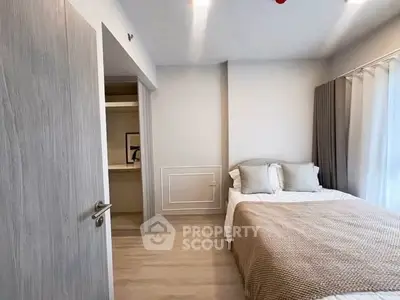 Cozy bedroom with modern decor and ample natural light