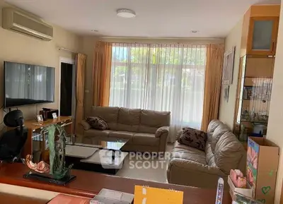 Cozy living room with large windows and comfortable seating