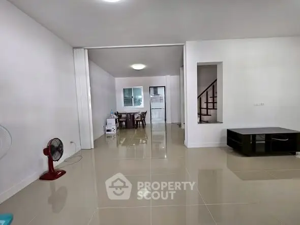 Spacious living room with glossy tiled floors and modern minimalist design.