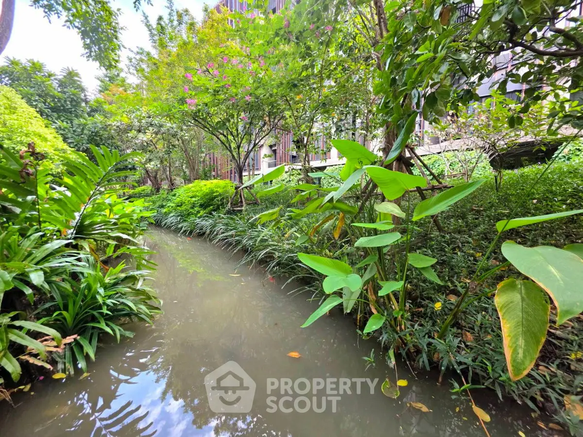Lush garden view with serene water feature in modern residential complex