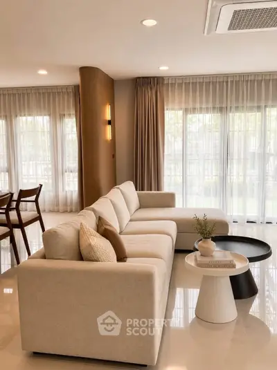 Elegant living room with modern beige sofa and stylish decor