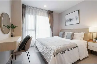Modern bedroom with stylish decor and natural light, featuring a cozy bed and elegant furnishings.