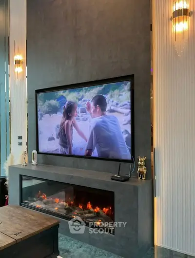 Luxurious living room with modern fireplace and large TV, perfect for entertainment and relaxation.