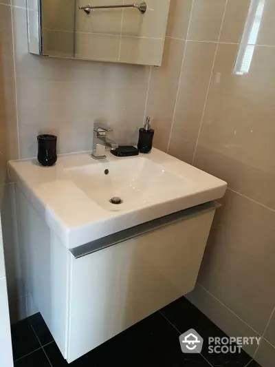 Modern bathroom with sleek sink and stylish fixtures in contemporary design.