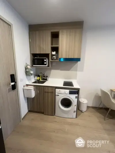 Modern compact kitchen with integrated washing machine and microwave