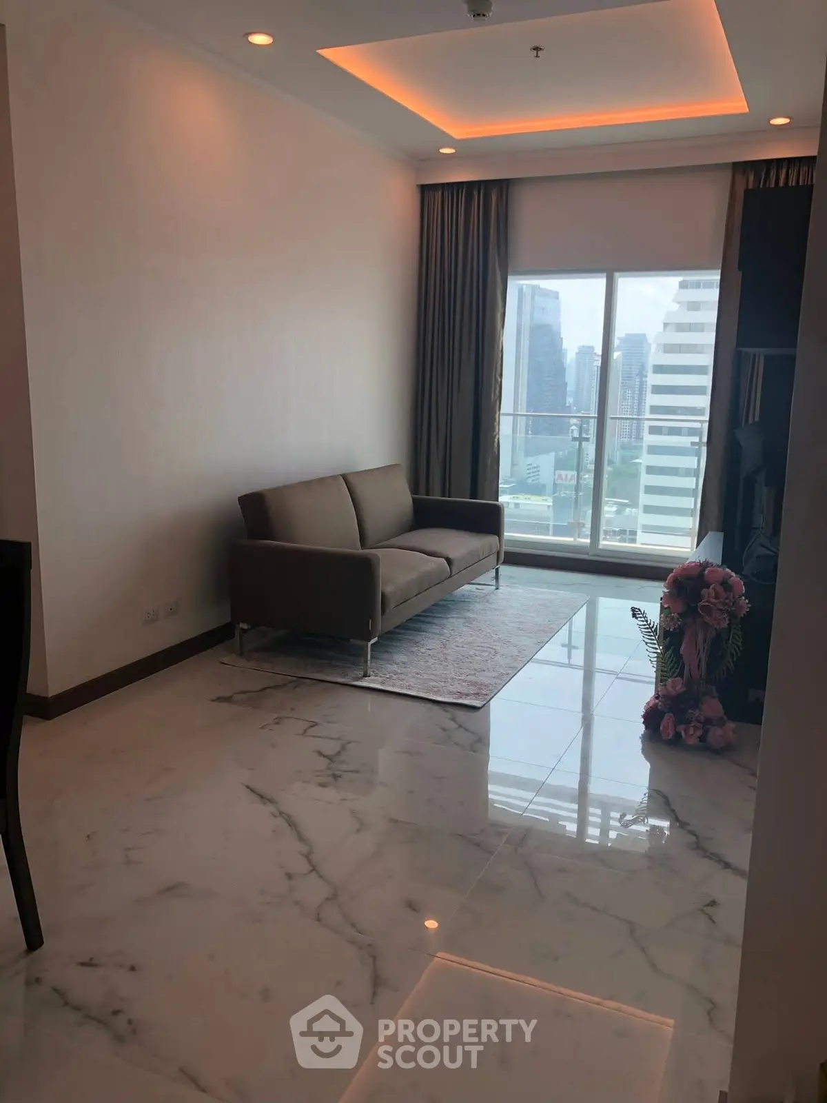 Modern living room with city view and elegant marble flooring.