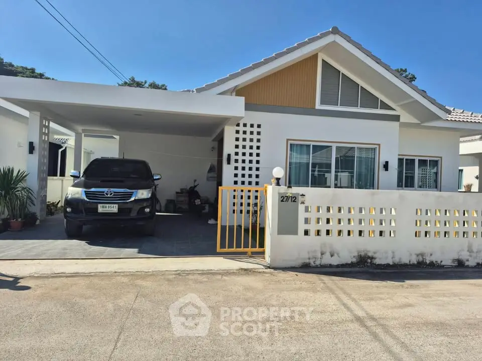 Charming single-story house with carport and modern facade in a serene neighborhood.