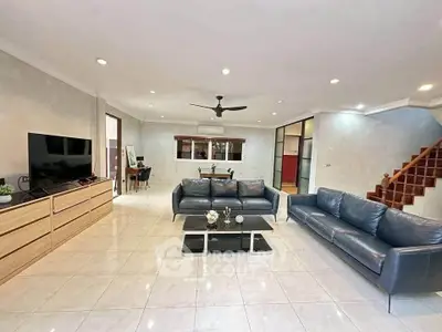 Spacious living room with modern furniture and open layout, perfect for family gatherings.