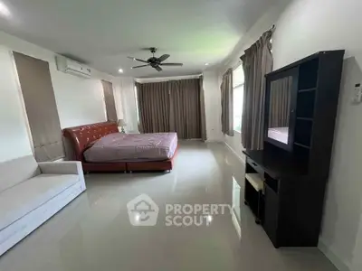 Spacious bedroom with modern furnishings and natural light