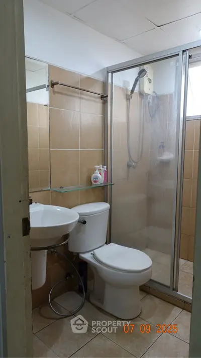 Compact bathroom with shower and modern fixtures, ideal for urban living.