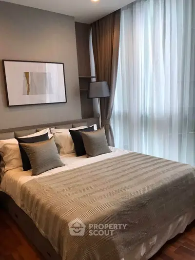 Elegant bedroom with modern decor and large windows for natural light