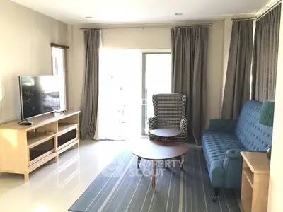 Charming living room with modern furniture, large window, and stylish decor, perfect for relaxation and entertainment.