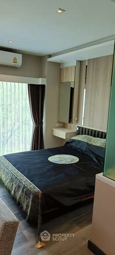 Modern bedroom with elegant decor and large window view