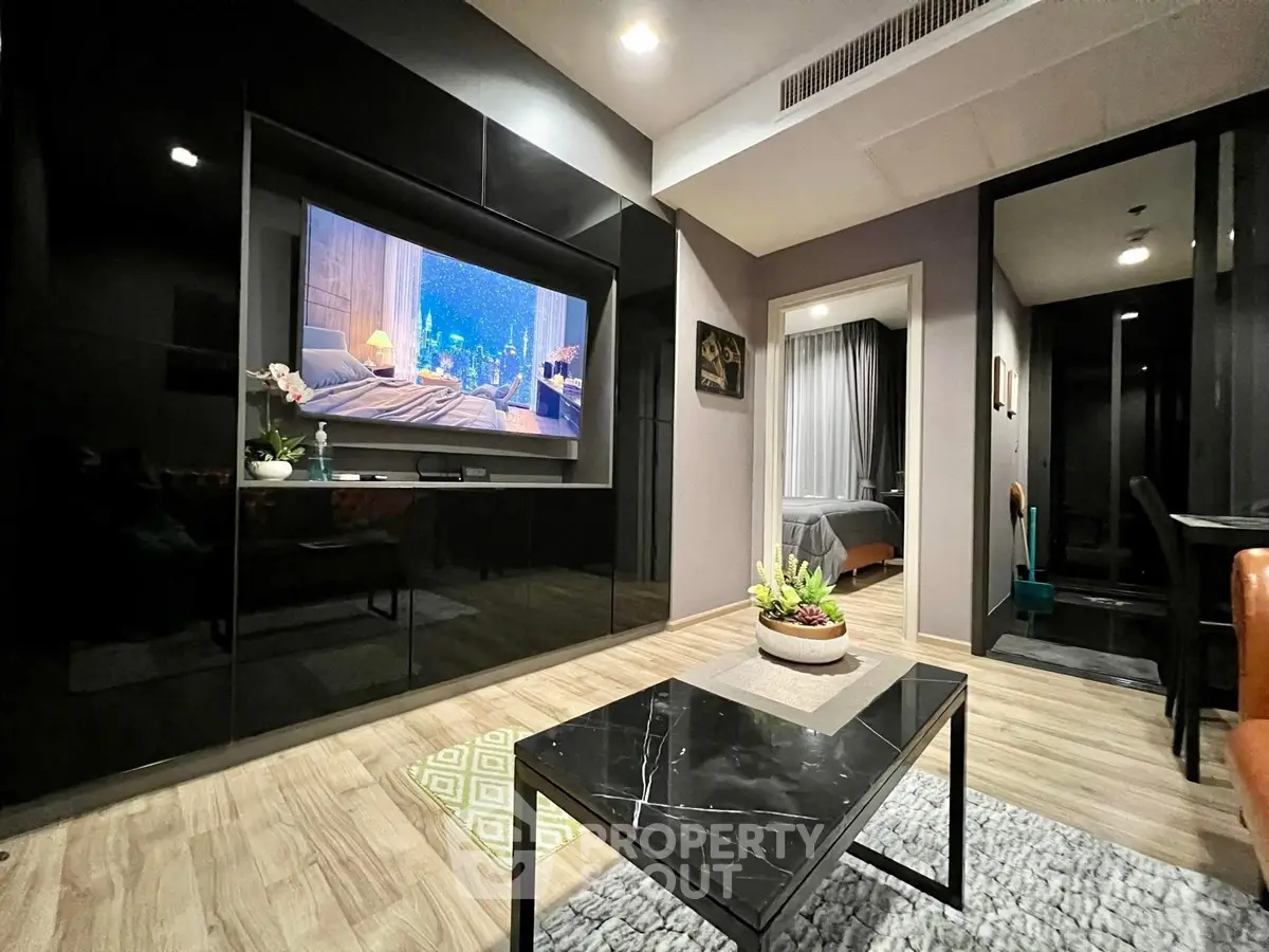 Modern living room with sleek black entertainment center and cozy decor