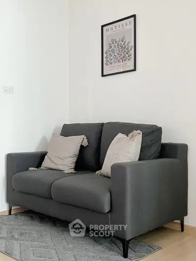 Cozy living room corner with stylish dark sofa and modern decor