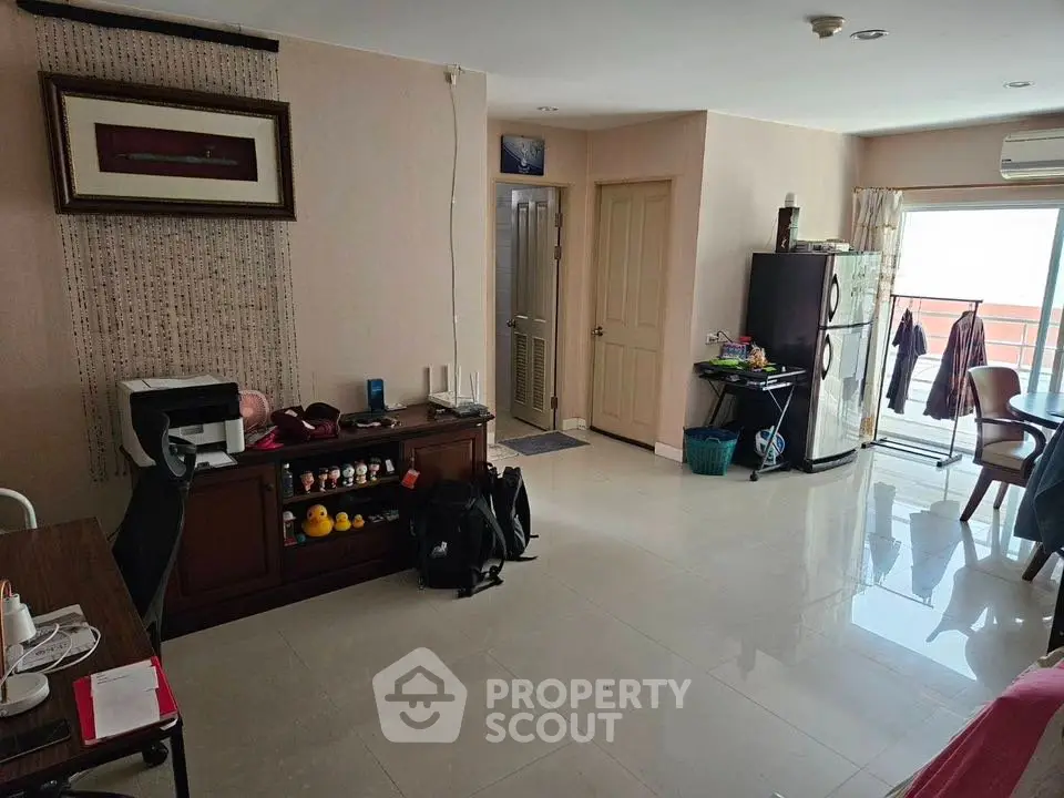 Spacious living room with modern decor and balcony access in a stylish apartment.