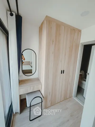 Modern bedroom with wooden wardrobe and stylish vanity mirror