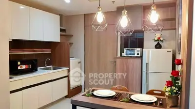 Modern kitchen with stylish lighting and dining area in contemporary apartment