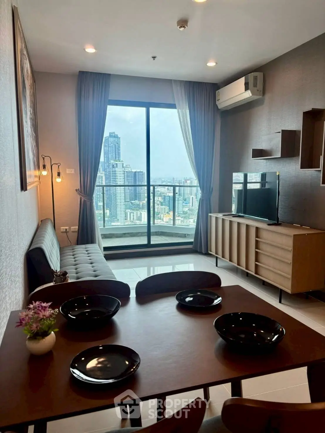 Modern living room with city view, stylish furniture, and elegant decor