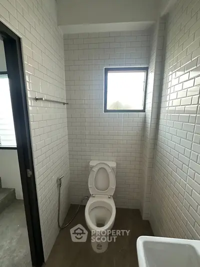 Modern bathroom with white subway tiles and natural light