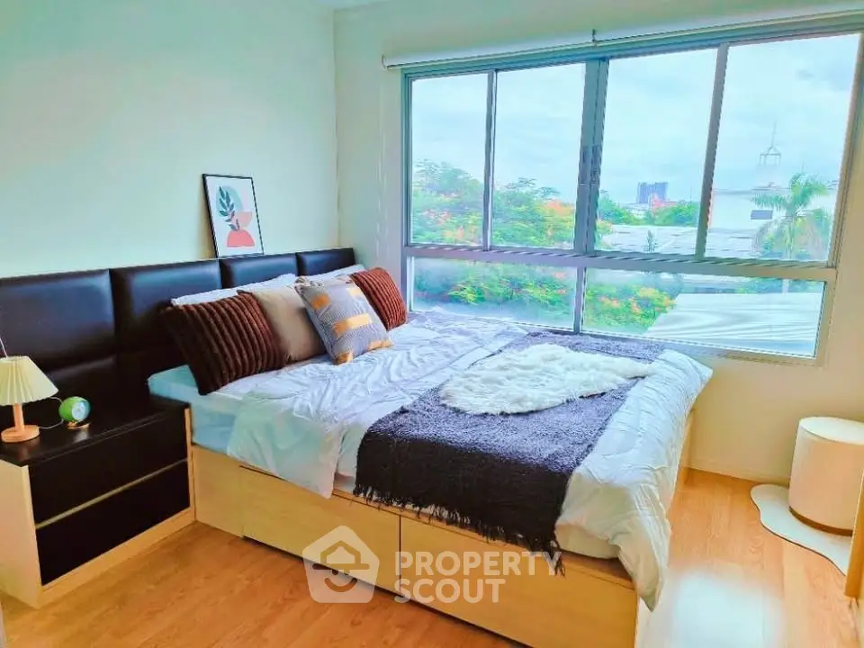 Bright and cozy bedroom with large window and stylish decor