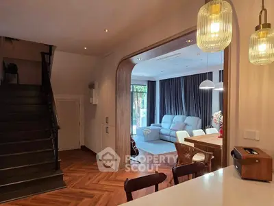 Modern open-plan living room with stylish lighting and cozy seating area