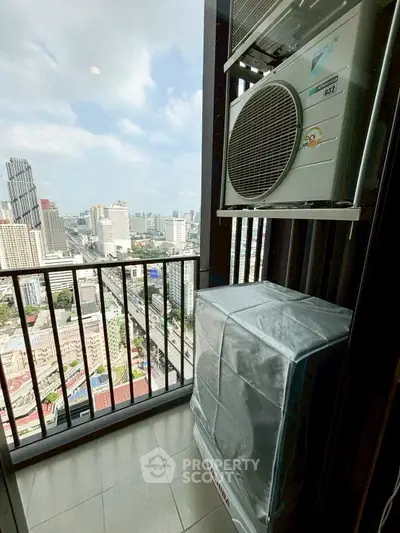 High-rise balcony with city view and air conditioning unit