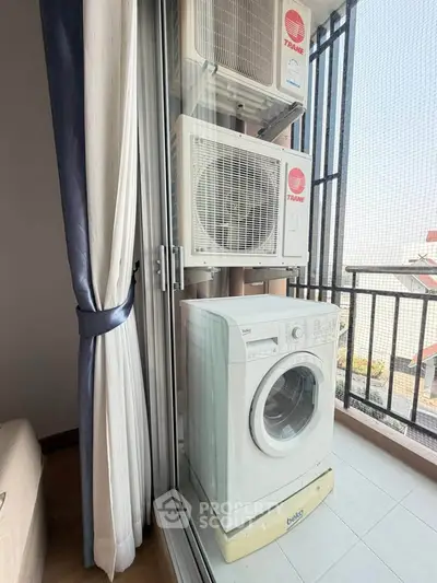Compact balcony with washing machine and air conditioning units, ideal for urban living.
