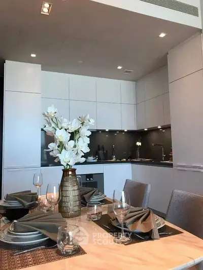 Modern kitchen with elegant dining setup and sleek cabinetry