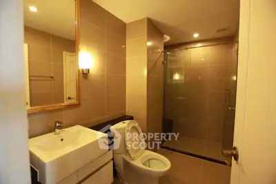 Modern bathroom with sleek fixtures and glass shower enclosure
