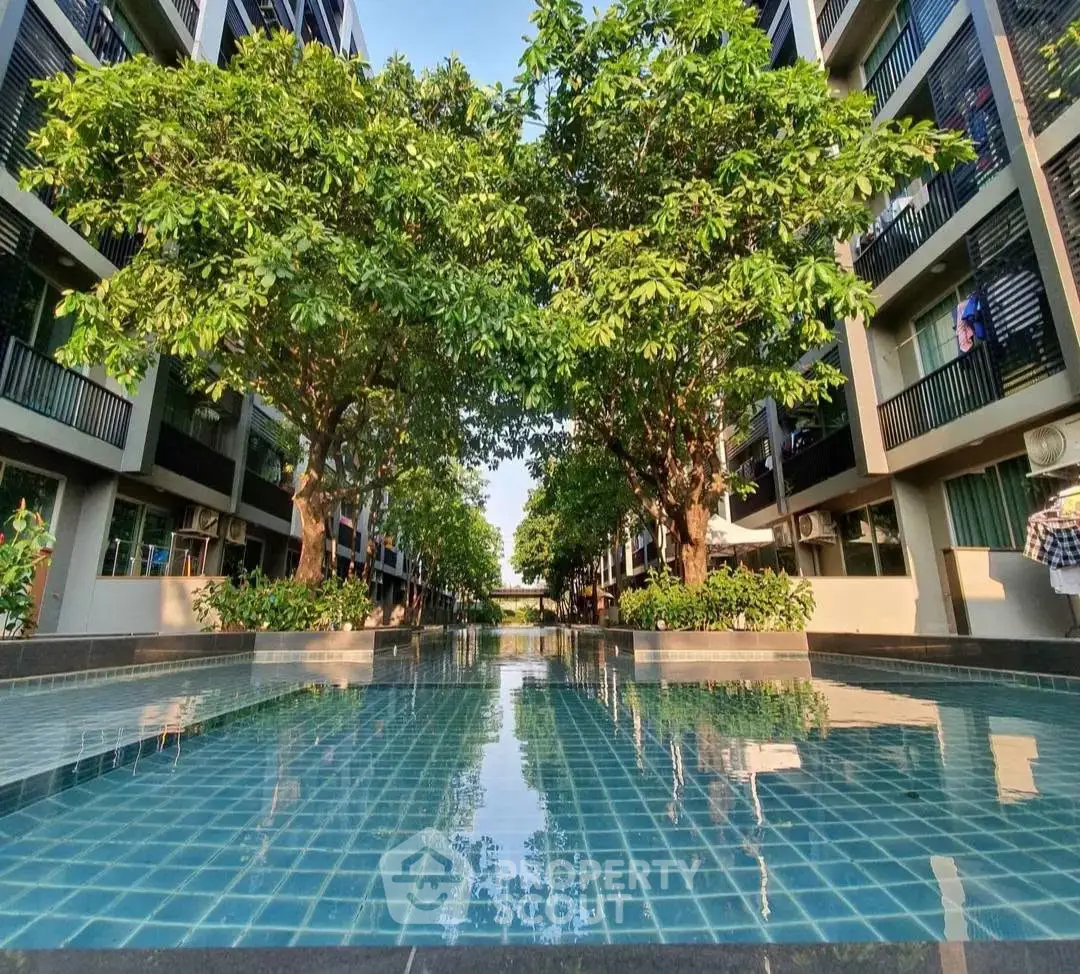 Stunning residential pool area with lush greenery and modern architecture, perfect for relaxation and leisure.