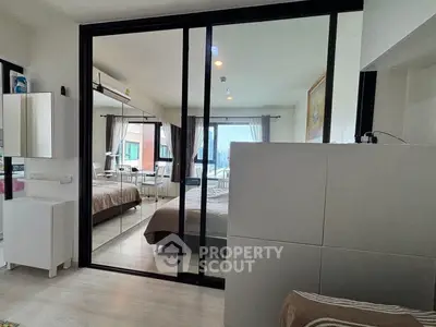 Modern bedroom with mirrored sliding doors and natural light