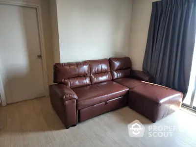 Cozy living room with stylish brown leather sofa and natural light