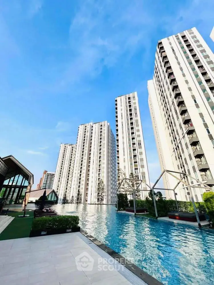 Luxurious high-rise apartment complex with stunning pool and modern architecture.
