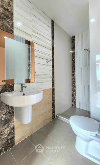 Modern bathroom with elegant tile design and sleek fixtures