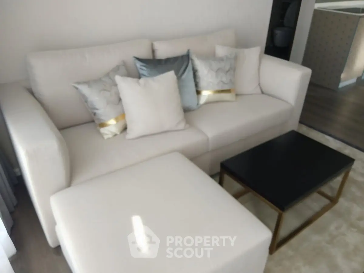 Modern living room with elegant sofa and chic decor in a stylish apartment.