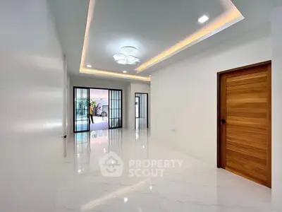 Spacious modern living room with sleek lighting and marble flooring