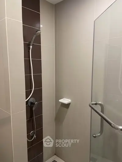 Modern bathroom shower area with sleek design and glass door