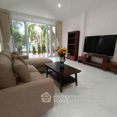 Spacious living room with modern decor and garden view