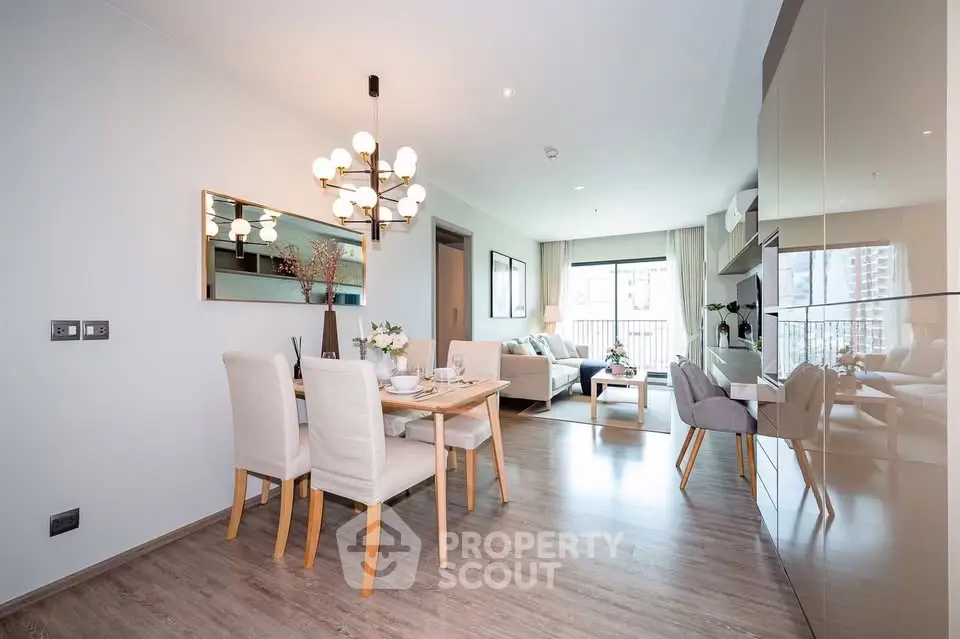 Modern open-plan living and dining area with elegant decor and natural light.