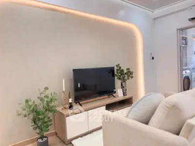Modern living room with sleek TV setup and ambient lighting