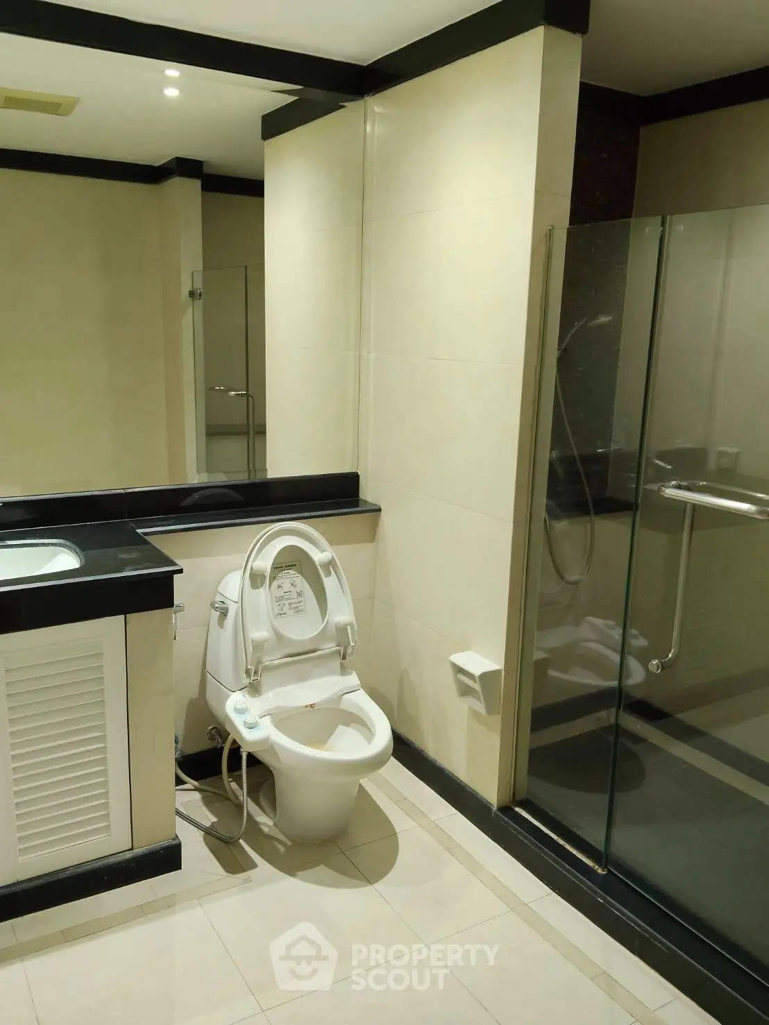 Modern bathroom with sleek design featuring a smart toilet and glass shower enclosure.