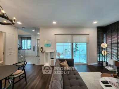 Modern living room with stylish decor and large windows offering natural light