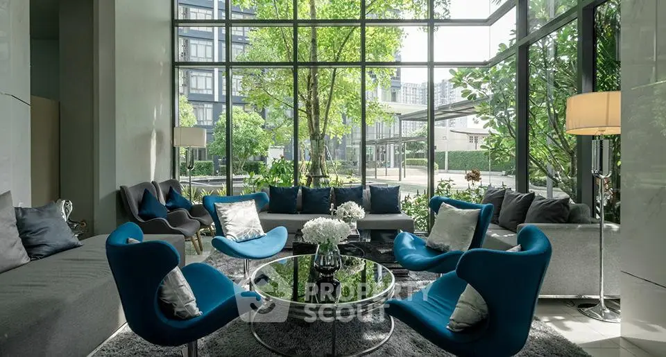 Luxurious modern living room with floor-to-ceiling windows and stylish blue chairs.