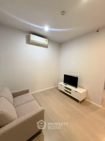 Modern living room with air conditioning and sleek furniture, perfect for cozy relaxation.