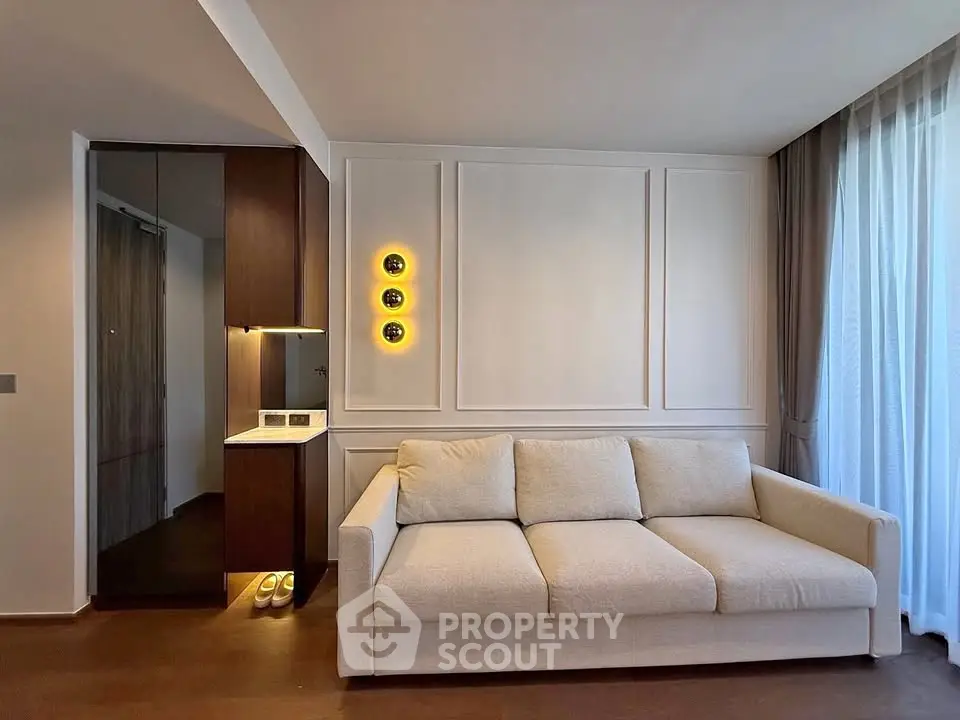 Modern living room with elegant sofa and stylish lighting in a cozy apartment.
