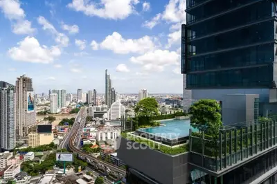 Stunning cityscape view with modern high-rise building and rooftop pool.